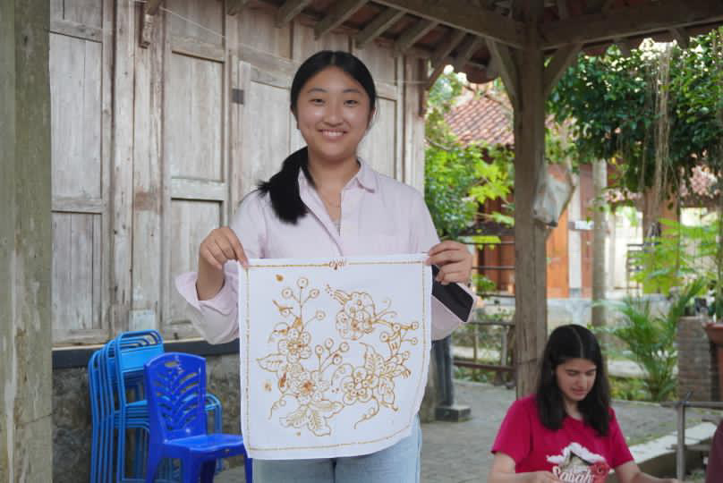 A student creating batik (ancient fabric tradition of JAVA, INDONESIA)