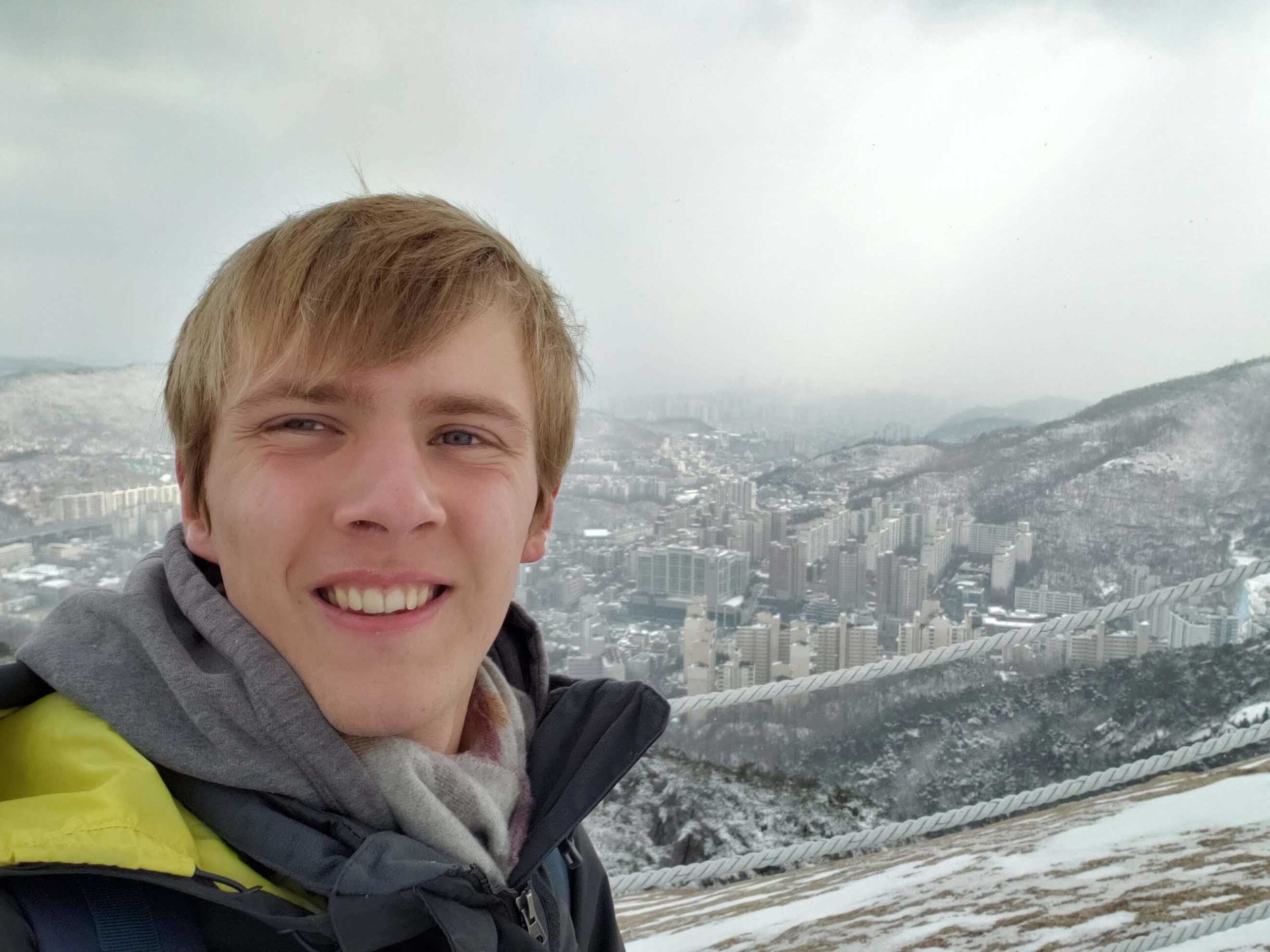 A photo of Zachary in front of a snowy landscape in South Korea