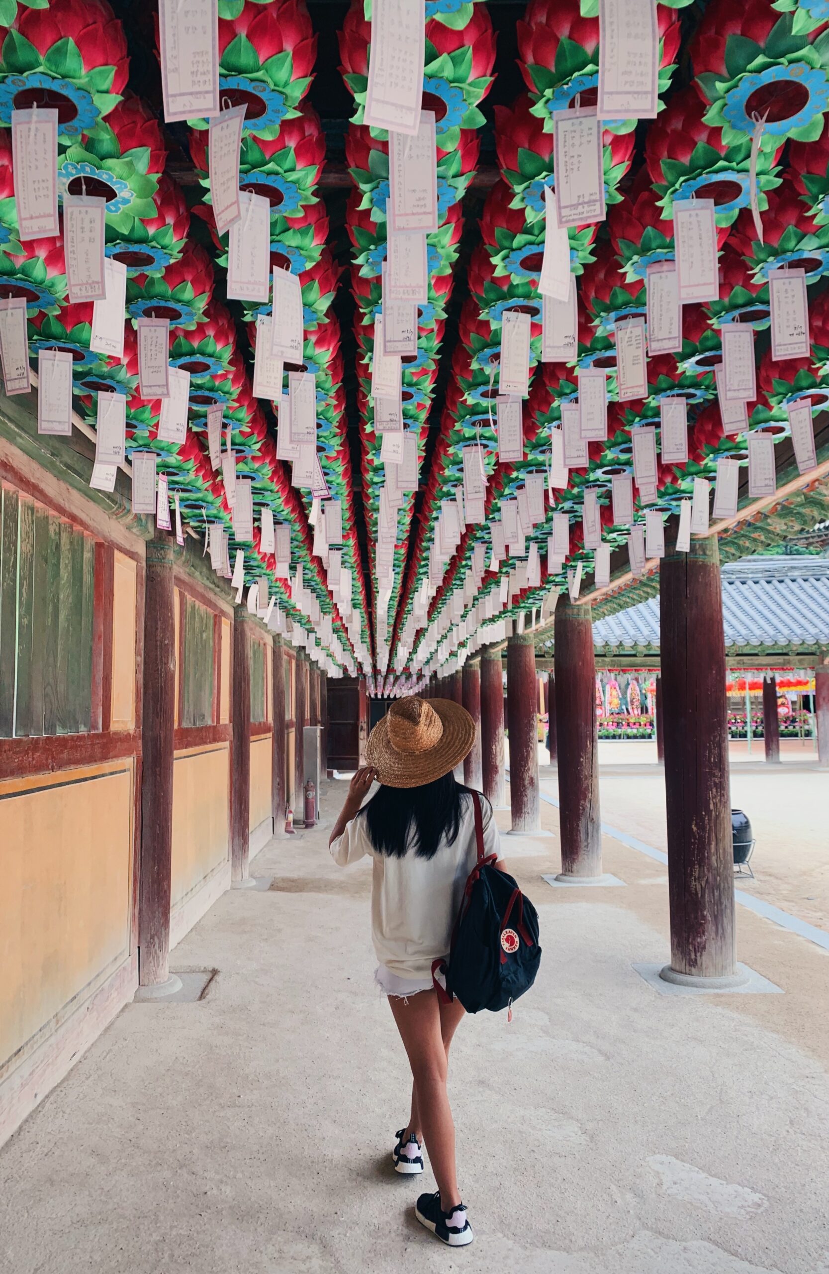 Claire poses under a ceiling full of lanterns in Korea