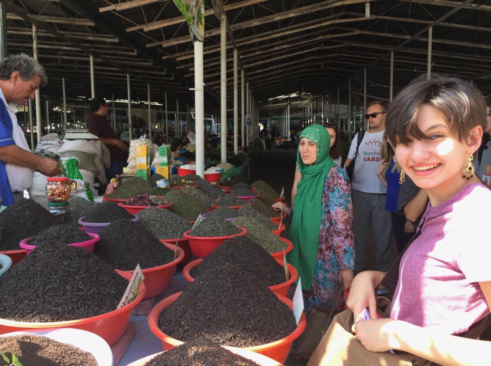 Mira posing in a market in Tajikistan