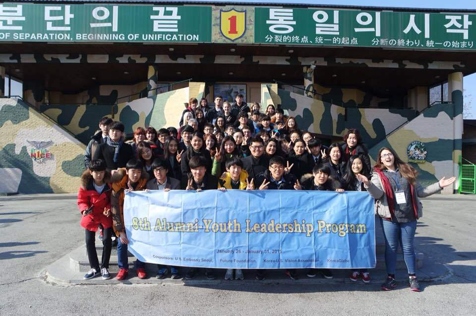 Image of NSLI-Y students posing with korean peers while holding a banner that reads