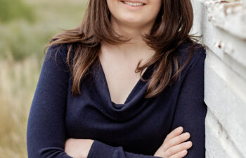A Chinese language alumna smiles for the camera