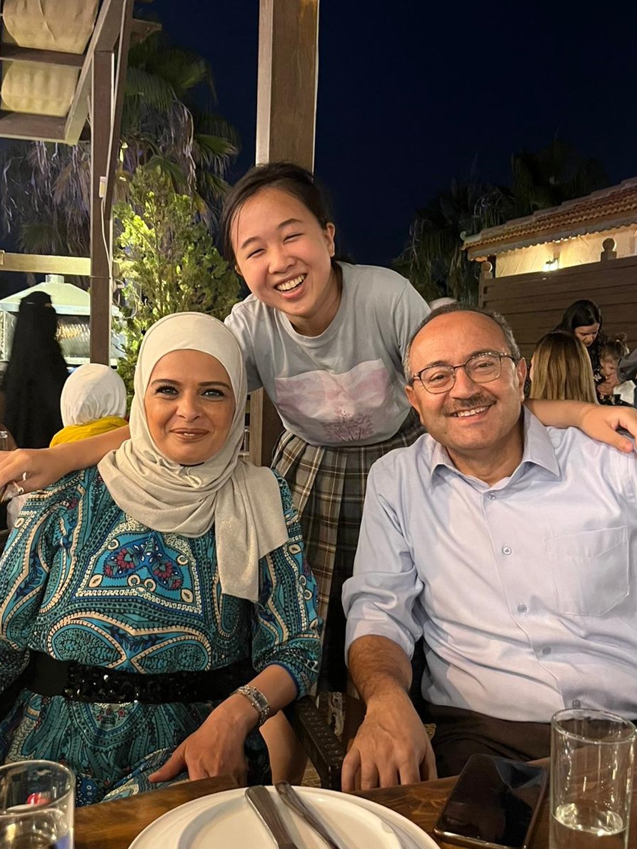 A student poses with her host family in Jordan
