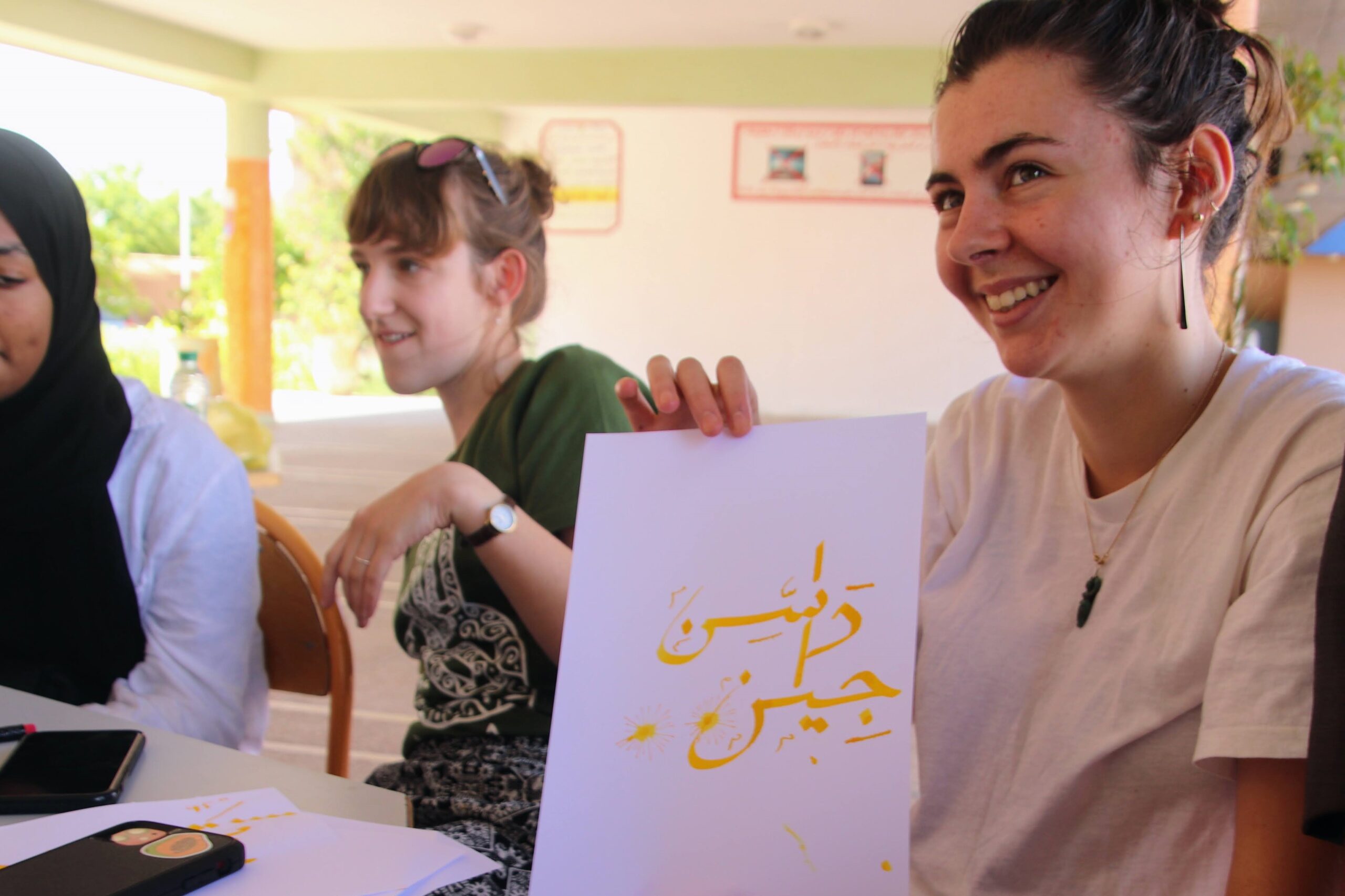 NSLI-Y Arabic participant in Morocco holding a paper with Arabic script
