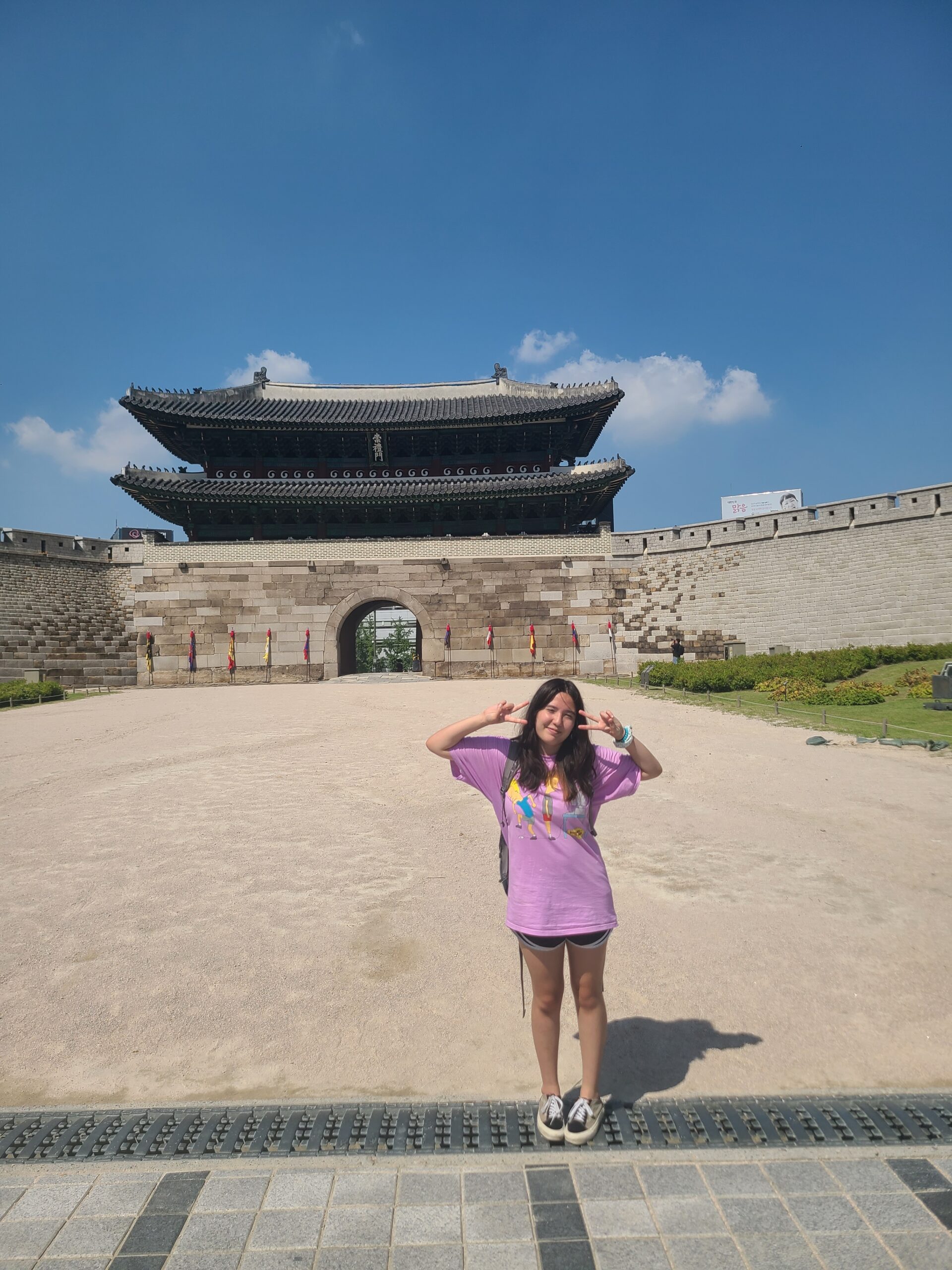 Ashley standing in front of a building in Korea.