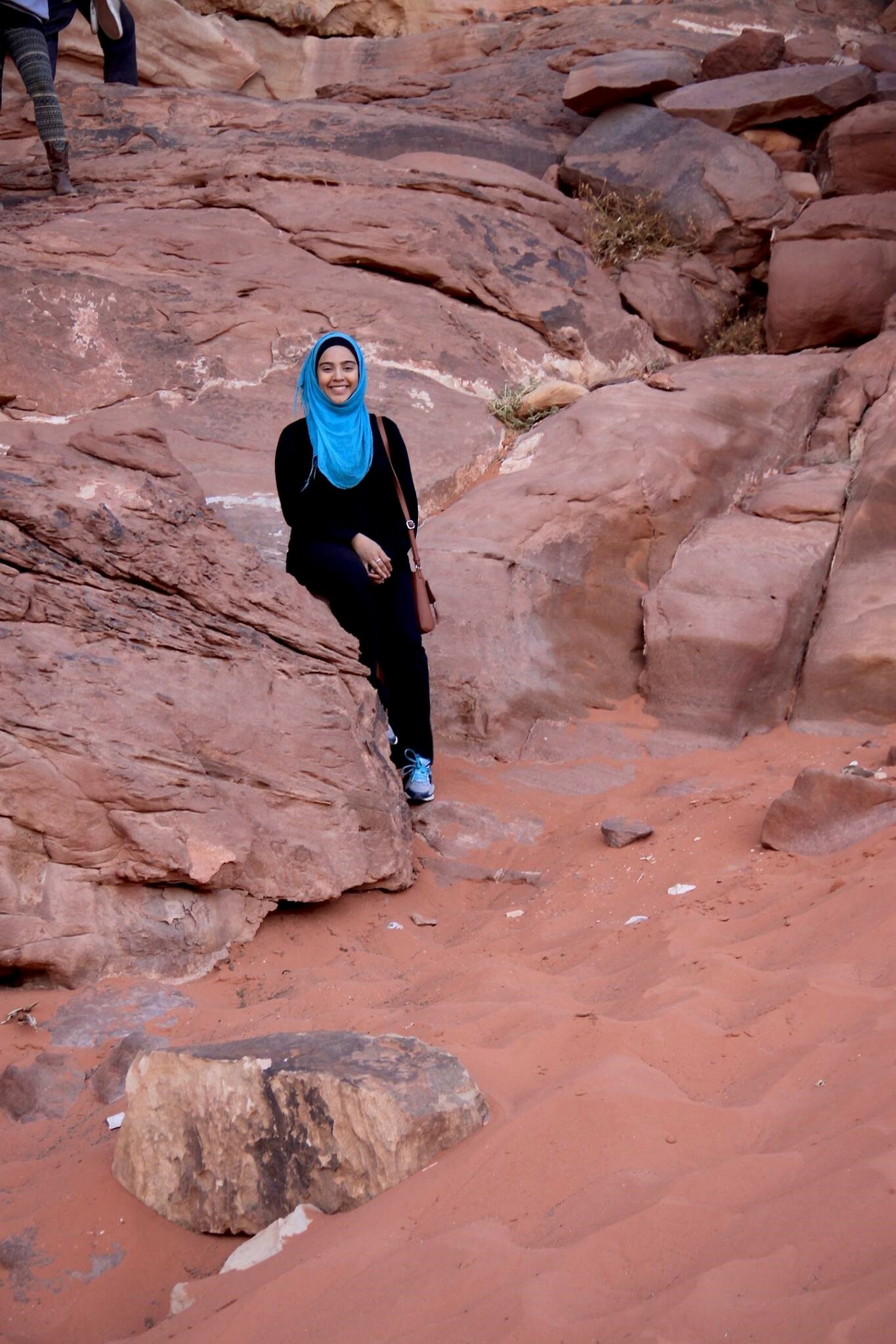Asma leaning up against a rock.
