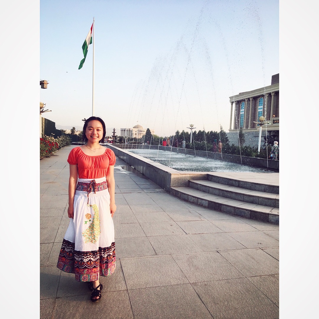 Vanessa posing in front of a flagpole in Dushanbe