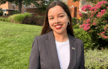 An alumna smiles for the camera