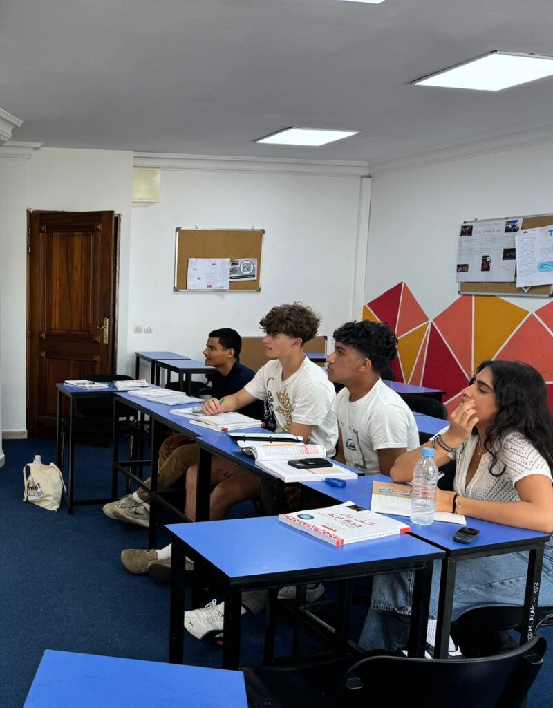 Four students at blue desk