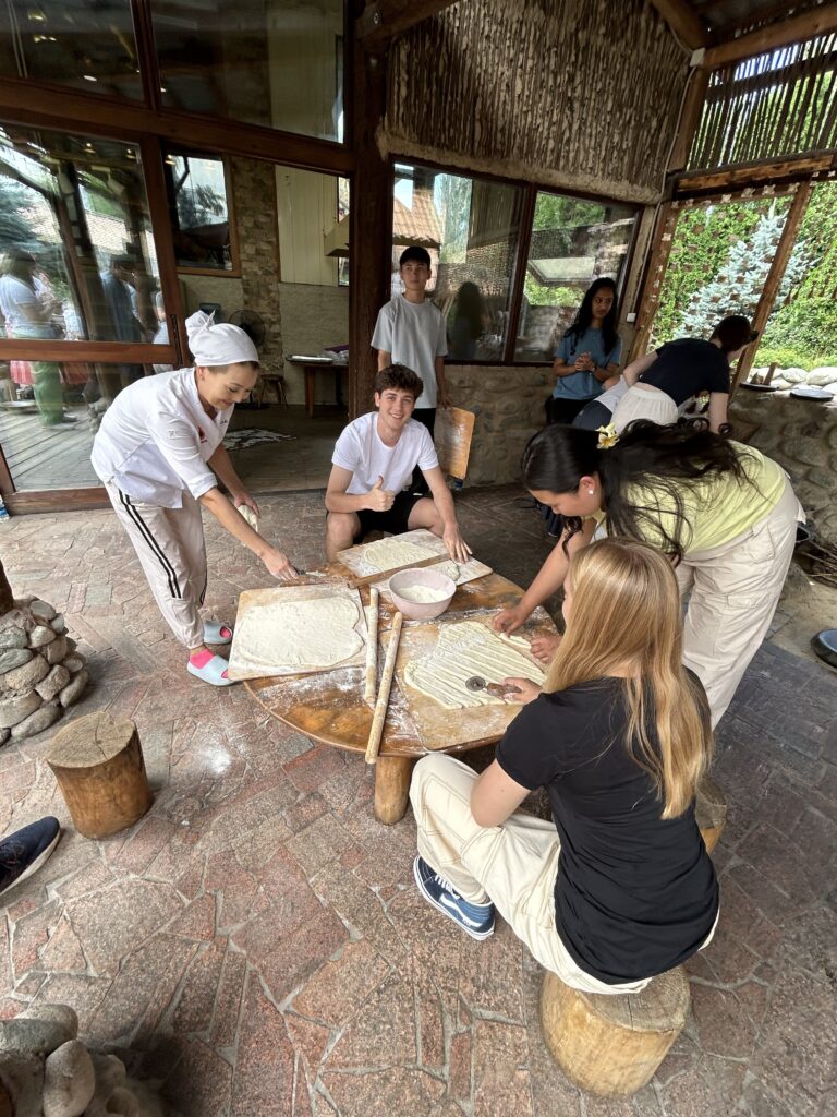 NSLI-Y Placement Three NSLI-Y students in Kyrgyzstan roll out dough while learning to make boorsook