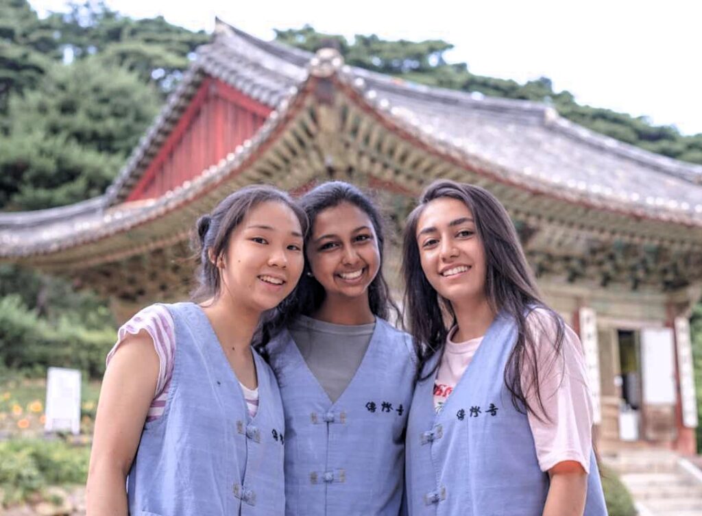 Three NSLI-Y Korean participants in blue vests on a cultural excursion