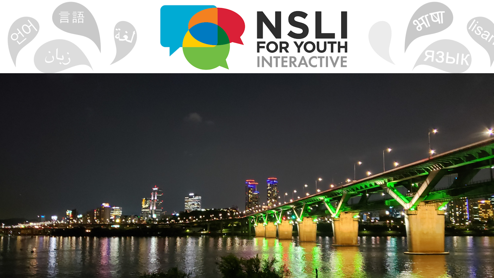 Image of the Seoul skyline at night; buildings overlooking the water light up in colorful colors against a black sky