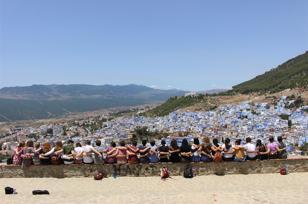 An image of the NSLI-Y Morocco cohort looking out over a mountain towards to the blue city of Chefchaouen