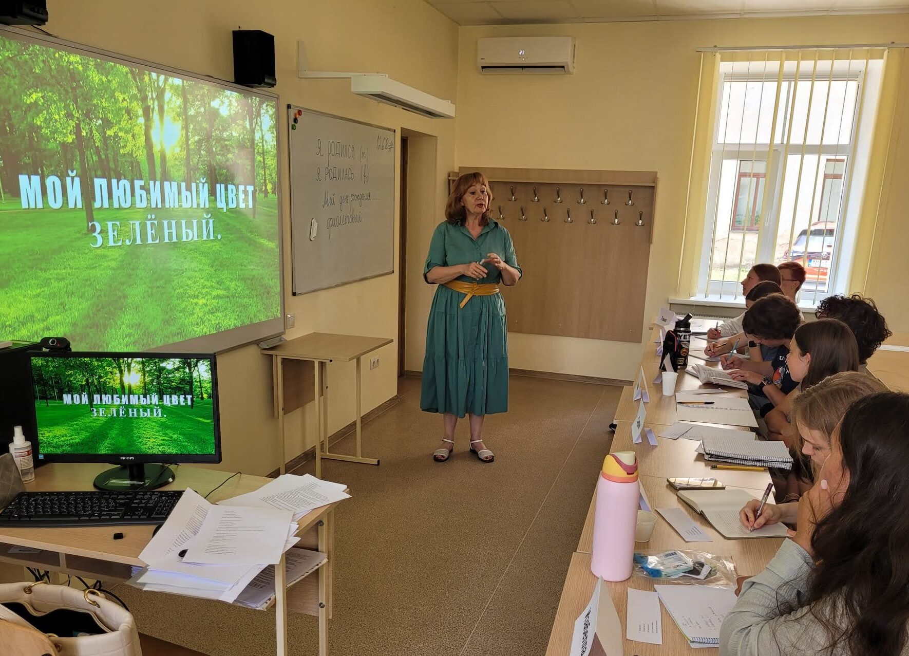A teacher leads in front of a Russian class
