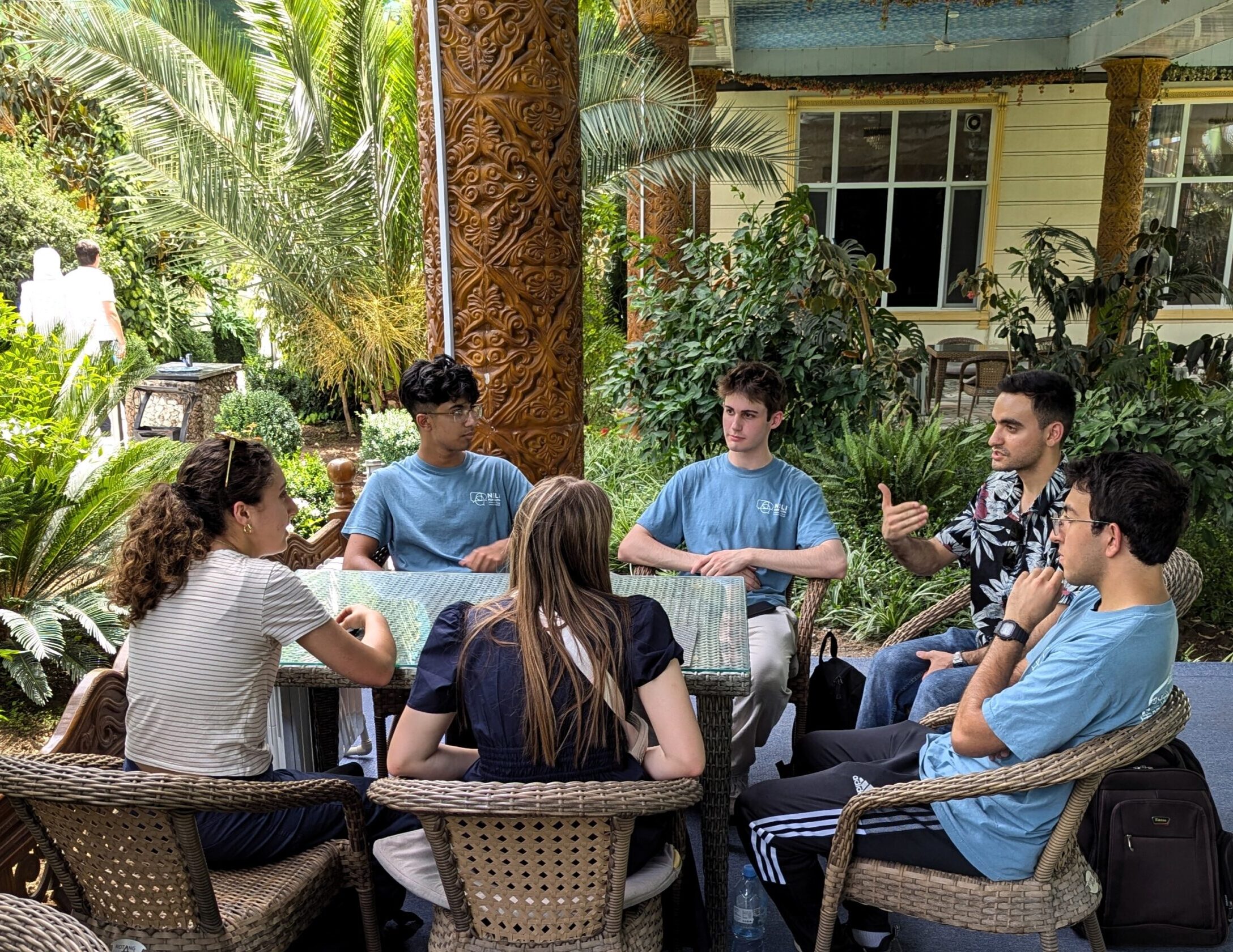 NSLI-Y Arabic language participants conversing outdoors around a table