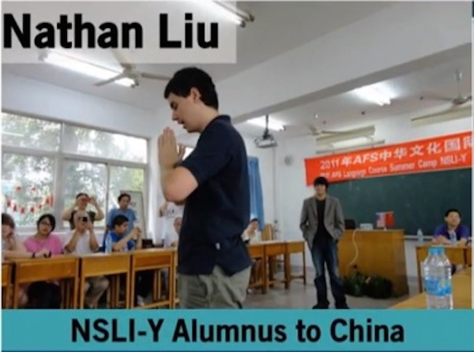 Image of Nathan standing in the middle of a classroom