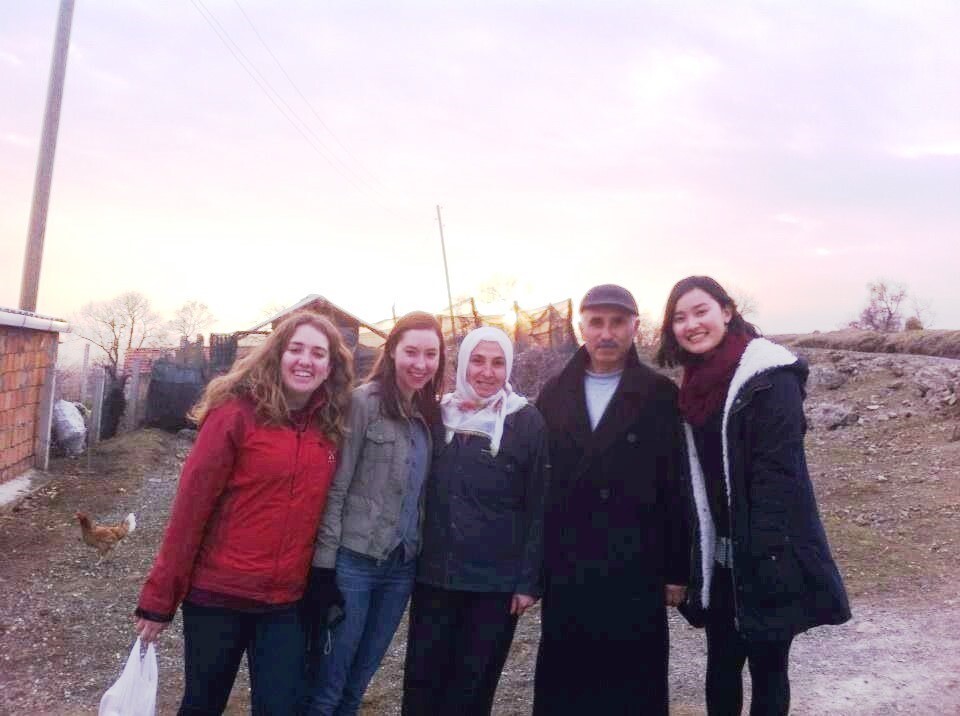 Image of NSLI-Y students posing outdoors with a pretty sky and rural landscape behind them