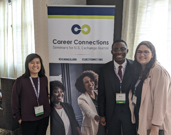 Diana posing in front of a Career Connections banner with two of her peers.