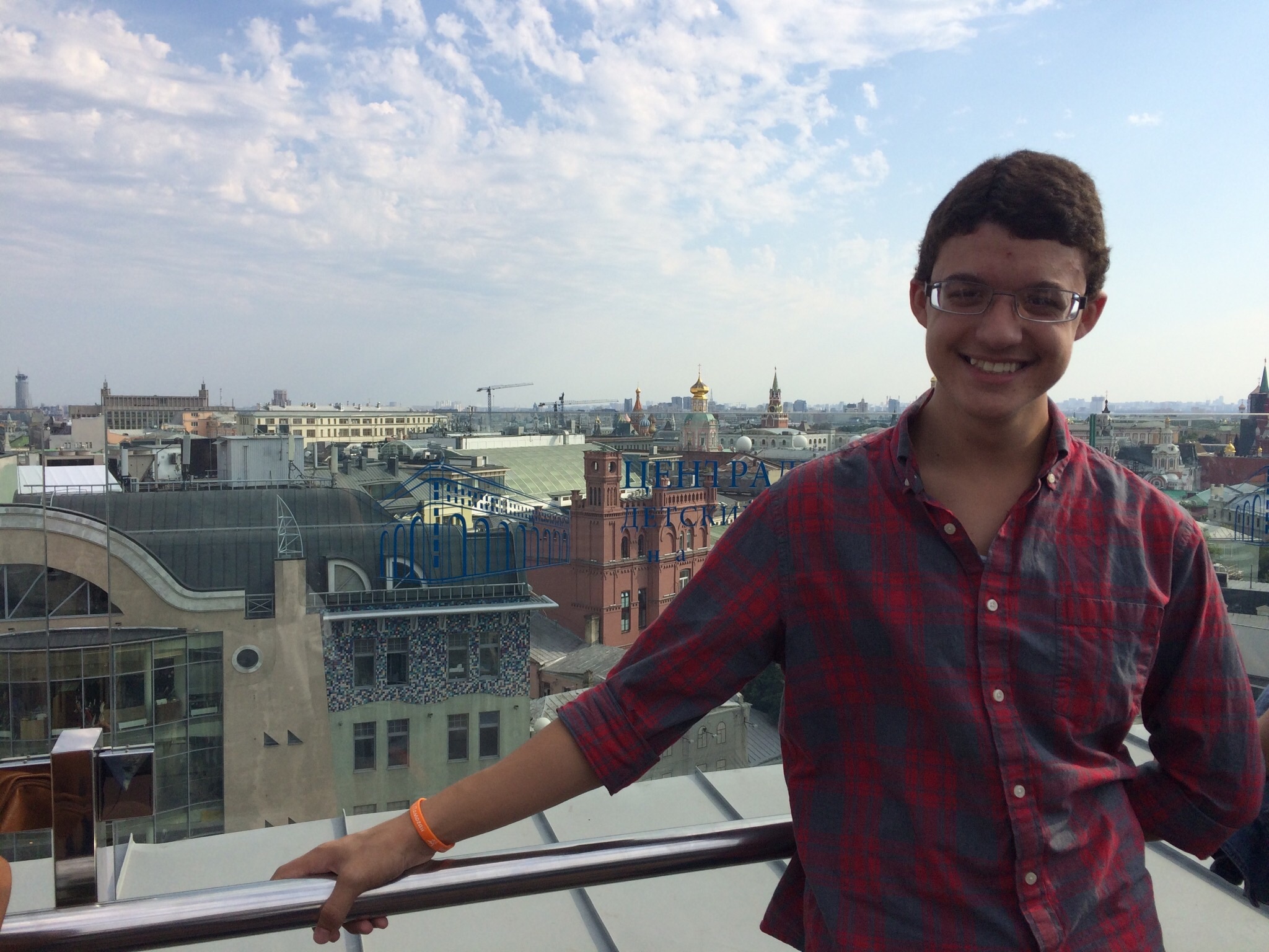 Image of Logan posing in front of a Russian cityscape