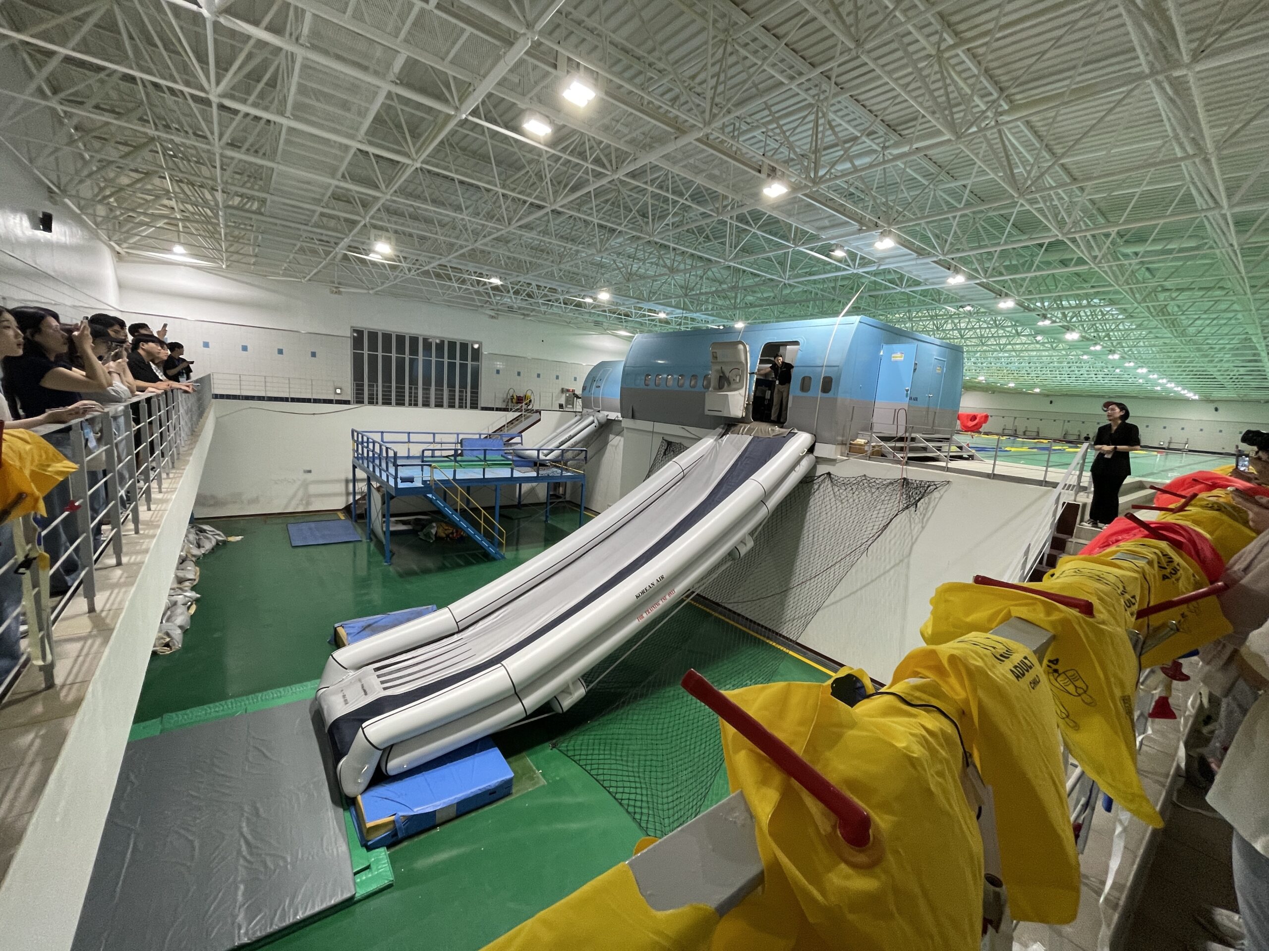 Students view an airplane emergency slide exhibit