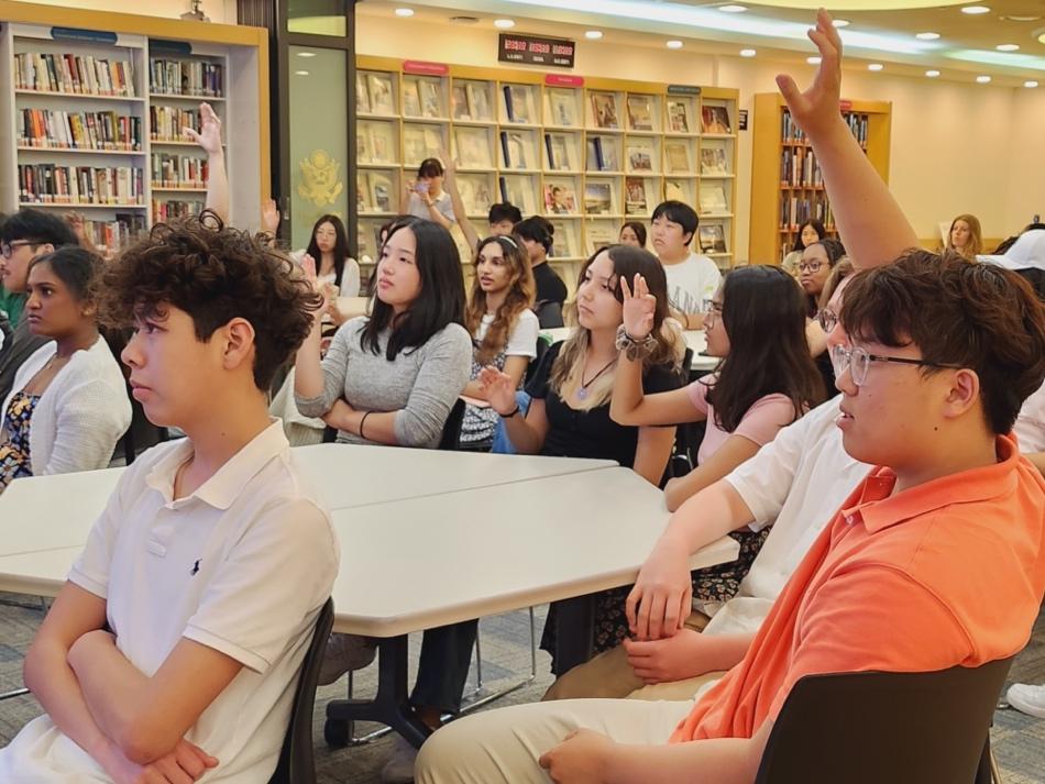 NSLI-Y participants in Korea. Some are raising their hands to ask a question.