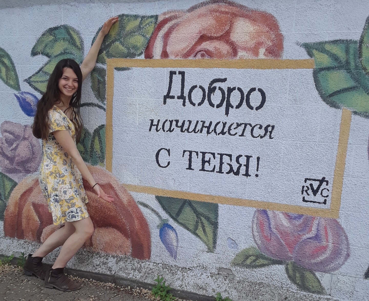 Elizabeth poses with a sign in Russia in Moldova