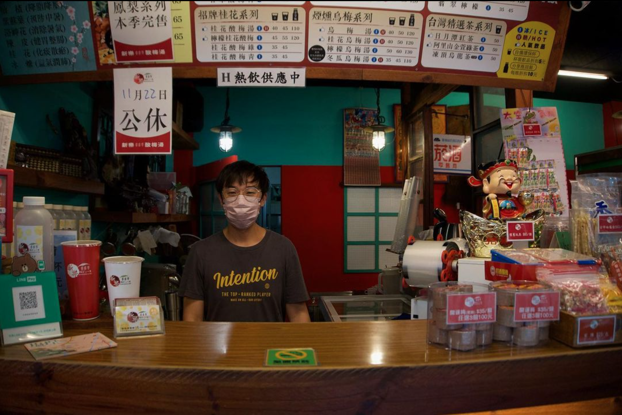 A shopkeeper stands behind the counter in Taiwan