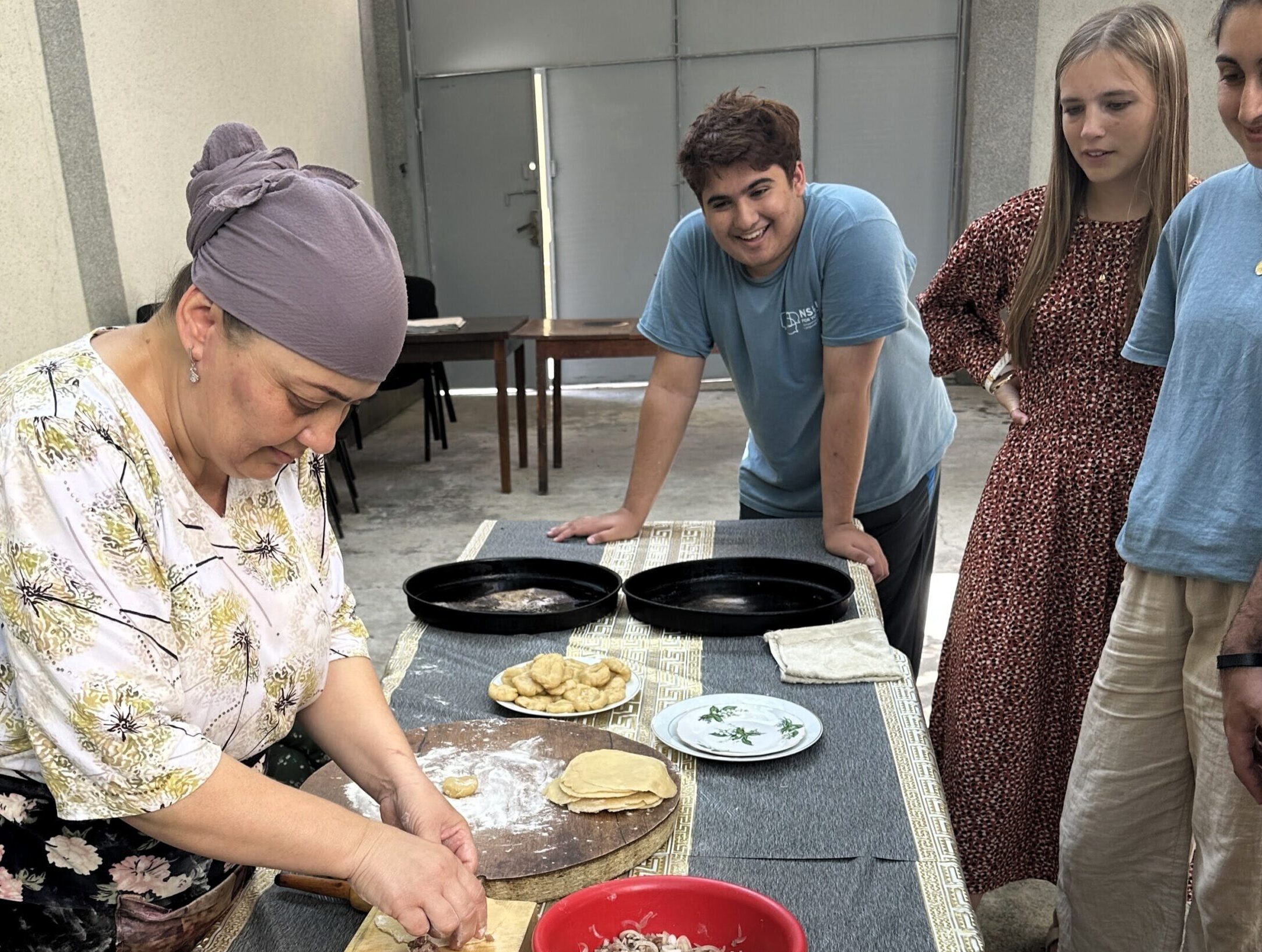 NSLI-Y Persian participants observing a cooking demo in Tajikistan