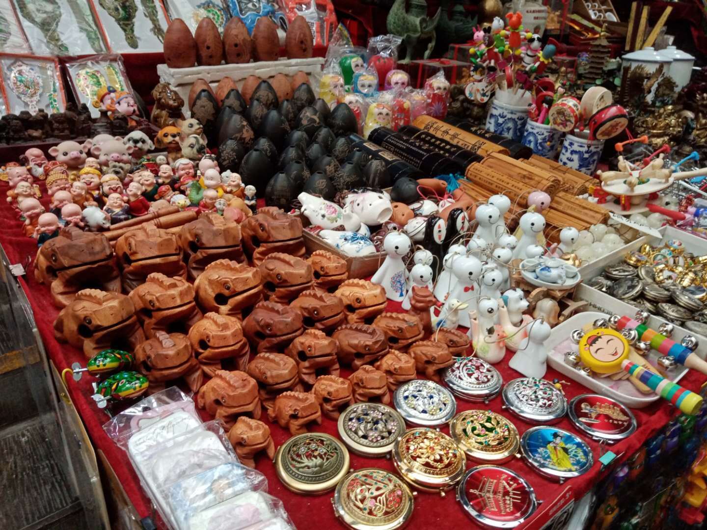 This photo shows goods sold at the Huimin Jie market. There is a table with a red table cloth